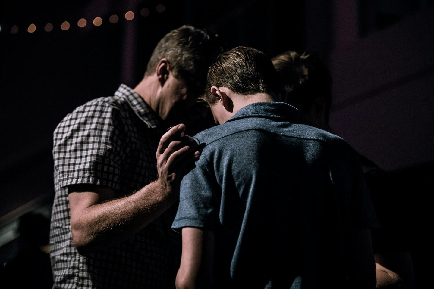 A group of men praying over each other.